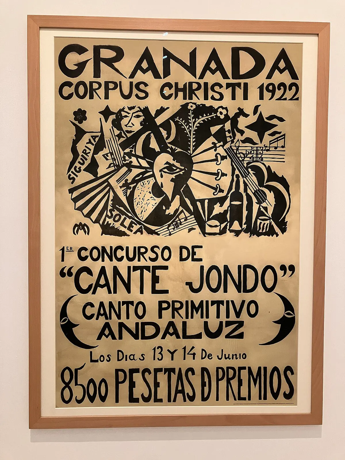 A framed poster reading Granada, Corpus Christi 1922, 1st Concurso de Cante Jondo, canto primitivo andaluz